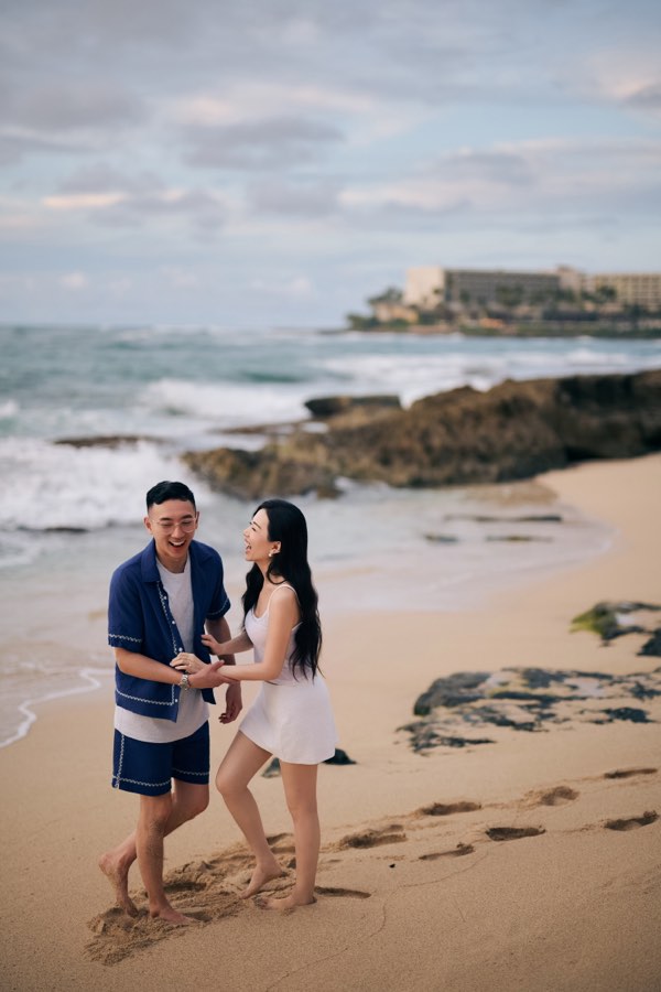 Michael and Nancy laughing together on a beach